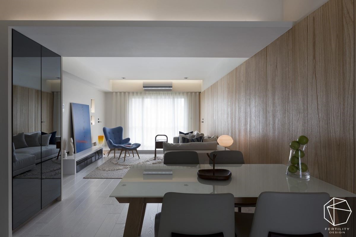 入口右侧则配置鞋柜，采用深色的亮面柜门，简单定义玄关与厅区领域，原本面对餐厅的厕所入口则加以转向，重塑开阔舒适的餐区。