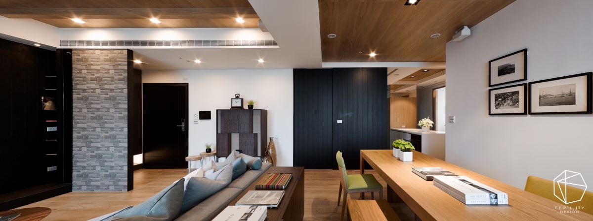 天花板则大量铺设橡木木皮，缔造温润质感，并以降版框设客厅上方的木梁设计，达到遮梁的目的。