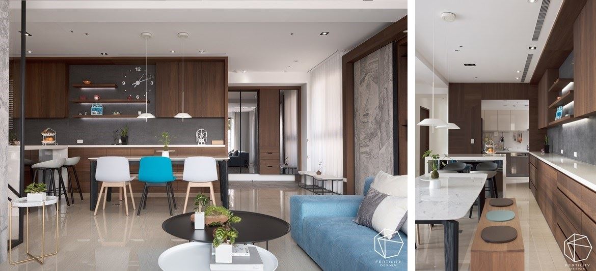 原先的中岛是 L 型，选择将柜体与中岛脱开，变为回字型动线，把餐厅、吧台、厨房三场域相互串联，餐桌也非制式刑事，一侧为单椅，另一端则是长板凳，更适合一家团聚使用，人多人少都适用。